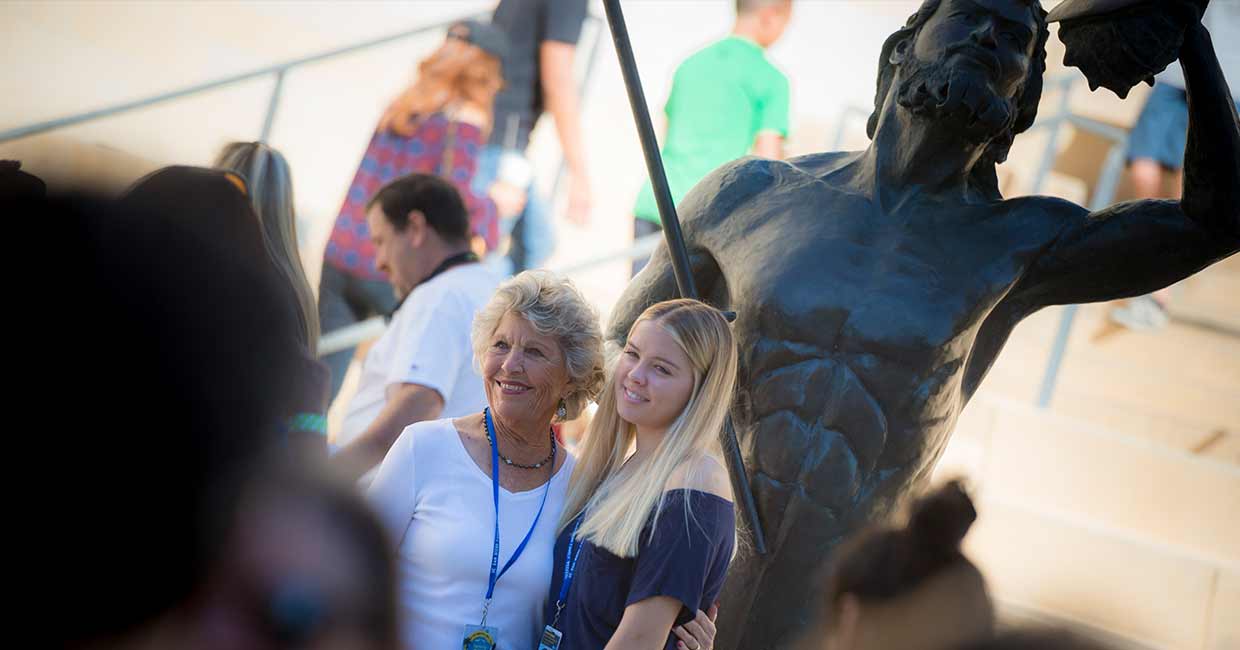 Mother and daughter taking a picture in front of the Triton statue