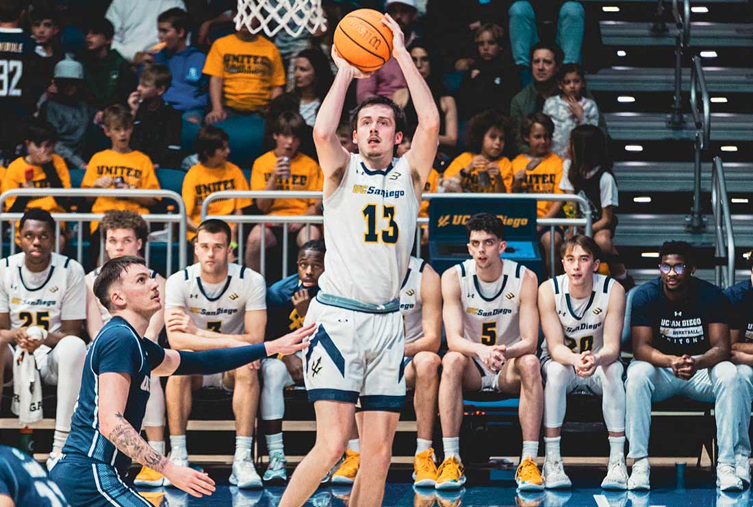 Male basketball player shooting a jumper