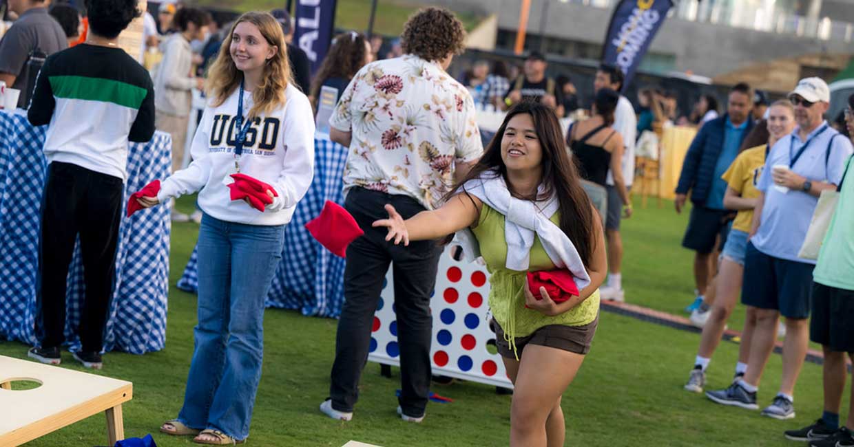 Two girls playing cornhole