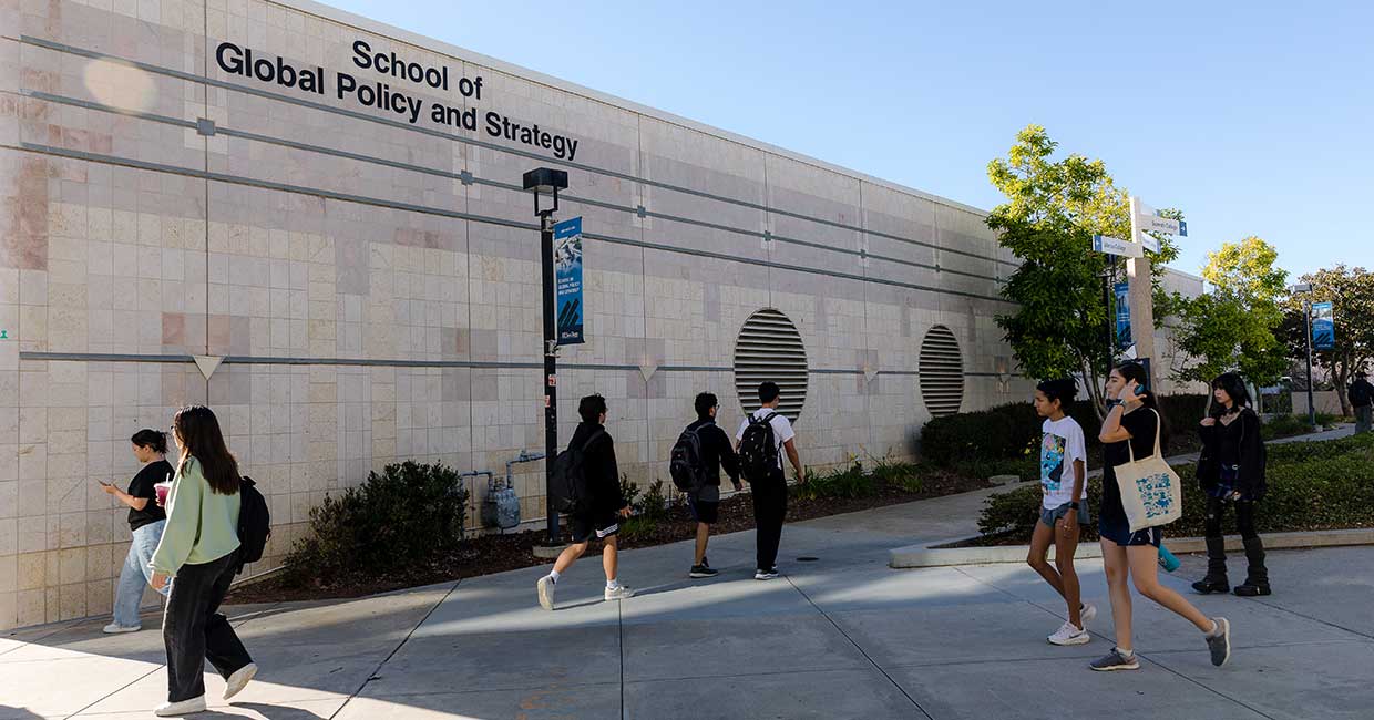 People walking by School of Global Policy and Strategy building