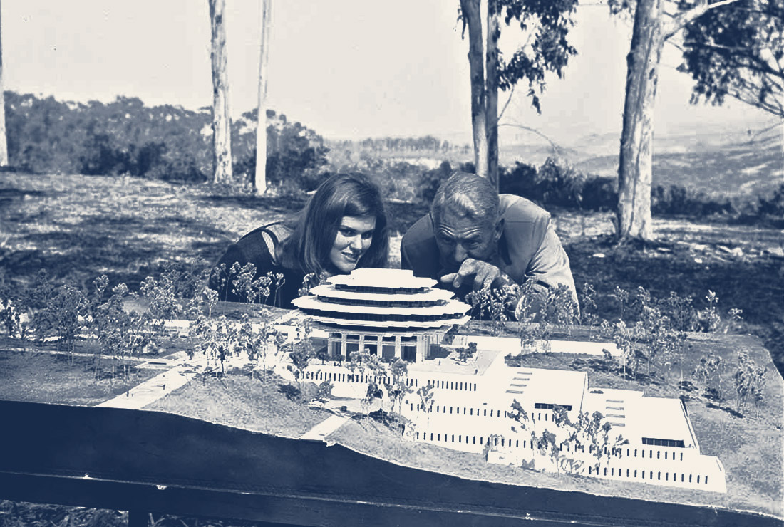 Man and woman looking at a Geisel Library model 